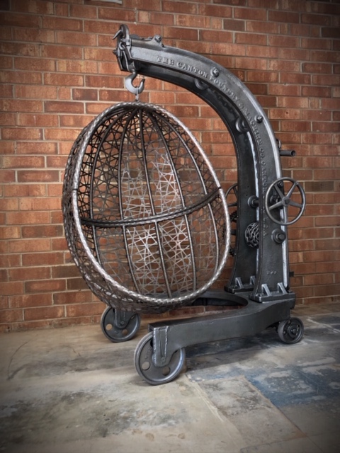 Rustic-industrial-hanging-egg-chair-with-antique-crane-stand-by-Chris-Lutzweiler