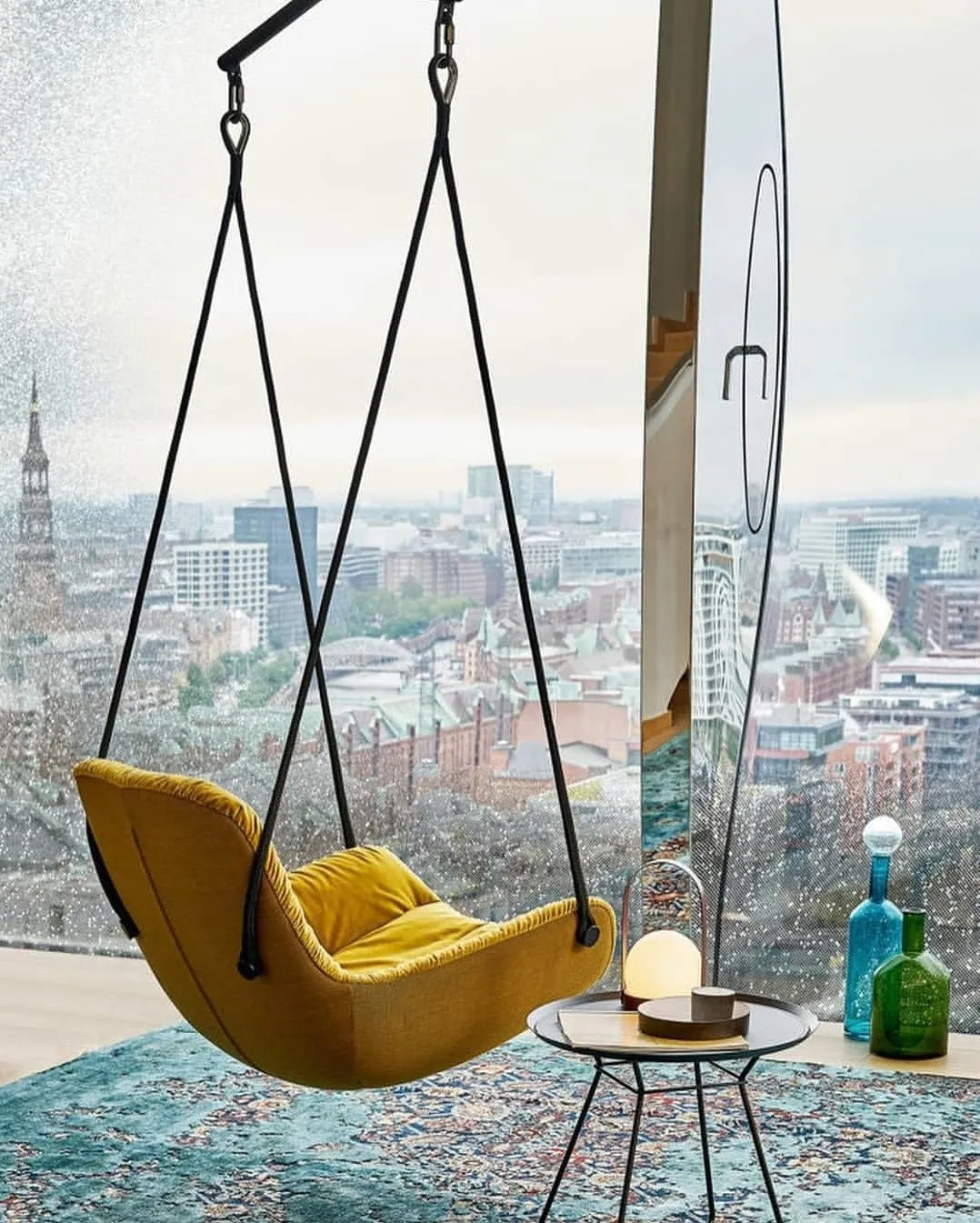 yelow-swig-seat-in-the-front-of-a-huge-window-with-beautiful-view